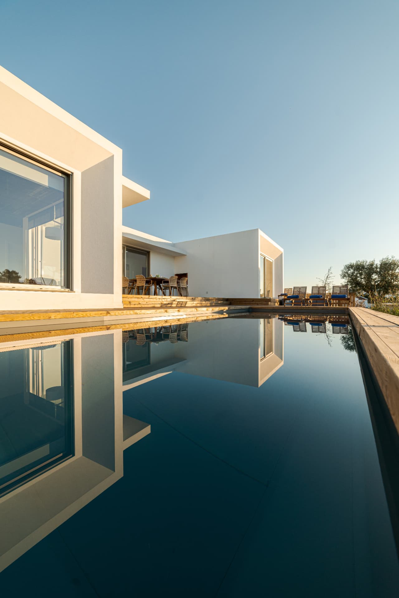 Modern white villa architecture reflected in a still swimming pool